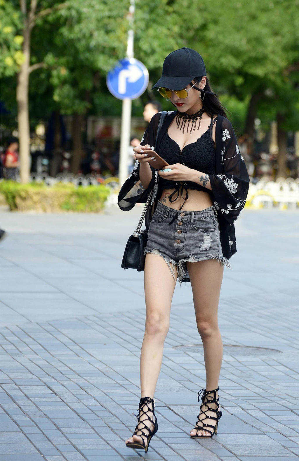 时尚小姐姐黑色紧身吊带裹出饱满丰腴身材，牛仔短裤随性搭配尽显