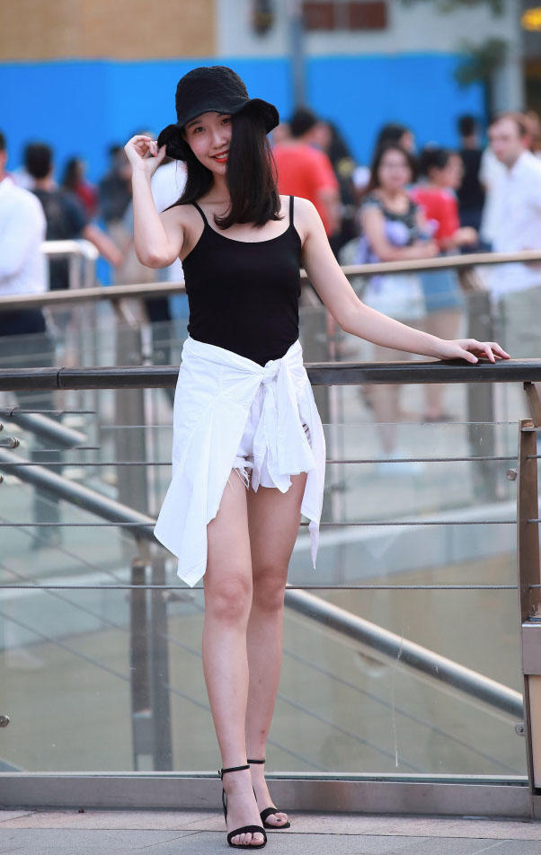 俏丽小姐姐贴身吊带背心勾勒饱满上围，小热裤显出精致翘臀