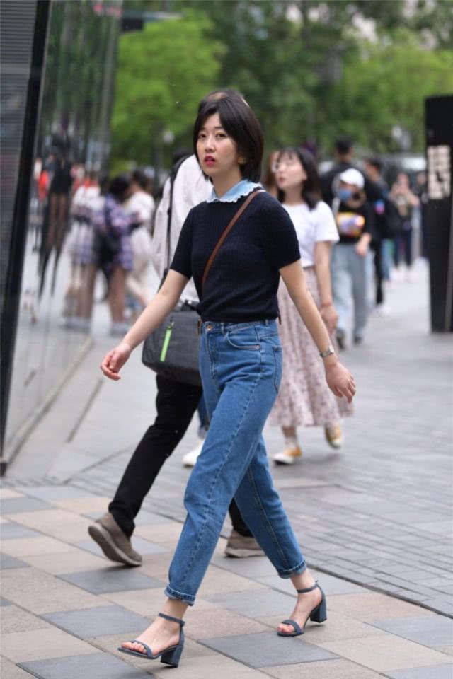  美女：街拍：美女身穿休闲衫配牛仔长裤，显得简约潇洒又有气质，彰显出落落大方的美感