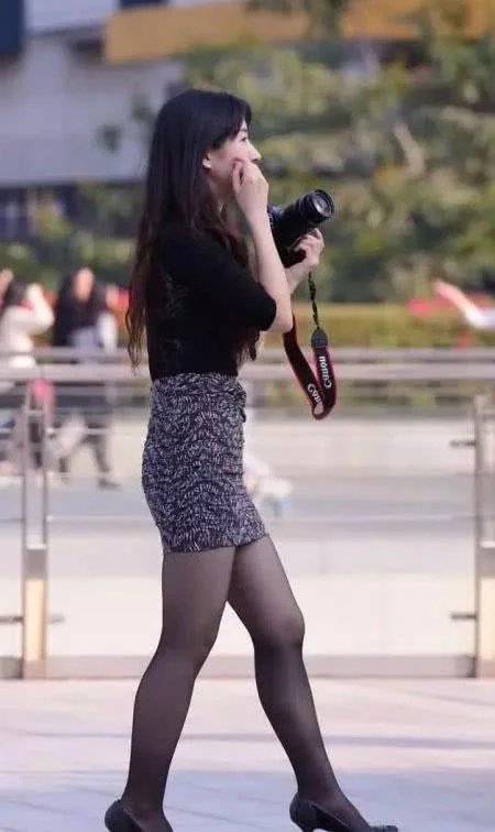 时尚御姐黑色衬衫搭配包臀裙，身材凹凸有致，玩起拍照笑逐颜开可