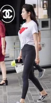 白色短袖与灰色打底裤之间的搭配,轻松展现了她优雅迷人的自信