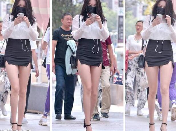 包臀裙很短了，美女还将裙子提的高高的，两个小开叉更显腿长！