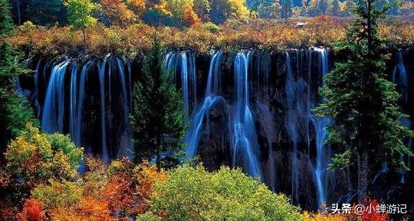 九寨沟的冬天山峦与树林银装素裹，瀑布变成巨大的天然艺术冰雕