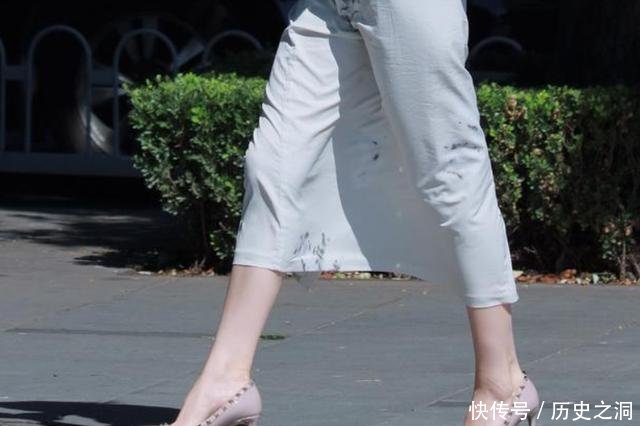 脚踩一双铆钉裸色高跟鞋，配上一袭长裙秀出女人柔和之美