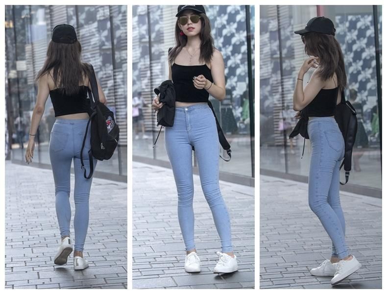 东莞街拍 修身的牛仔裤遇到紧身上衣 让美女姐姐突围的身材更丰满