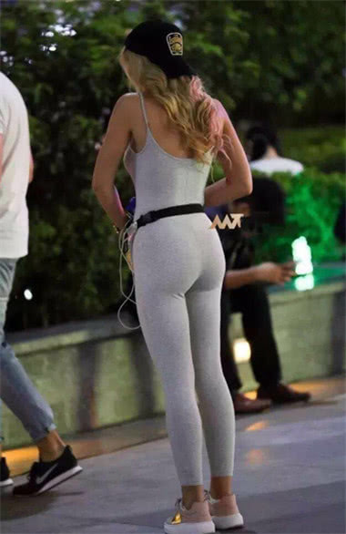 小姐姐白色紧身裤勾勒奥妙的圆润线条，夜色下朦胧可人