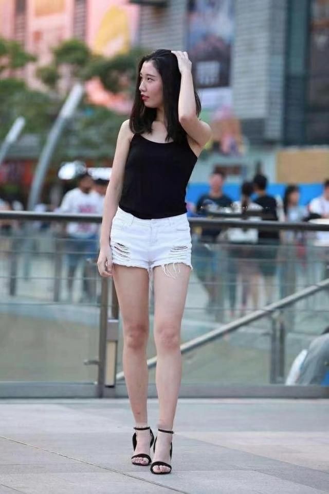 可爱女生牛仔热裤搭配高跟鞋，一双大长腿让人羡慕