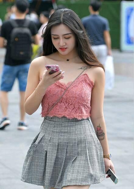 美女一身蓝色吊带背心，显示出自己的胸围，很性感！