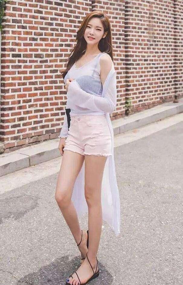 苗条的小姐姐穿着修身牛仔短裤，将小姐姐长腿拉伸的十分修长迷人