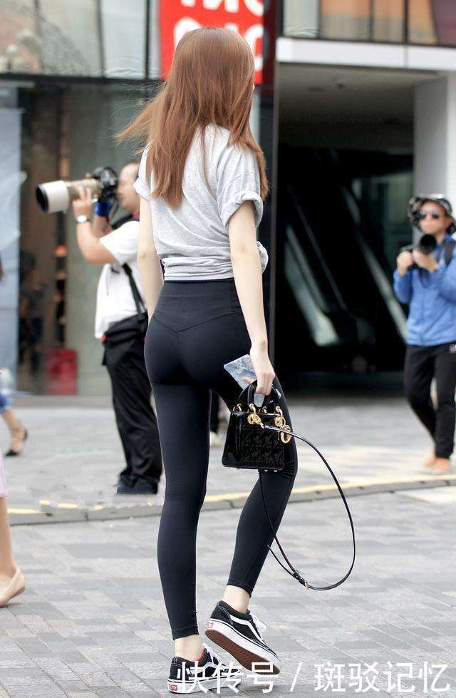 街拍：紧身黑裤搭配灰色短袖卡通上衣的水蛇腰小姐姐，身材真好