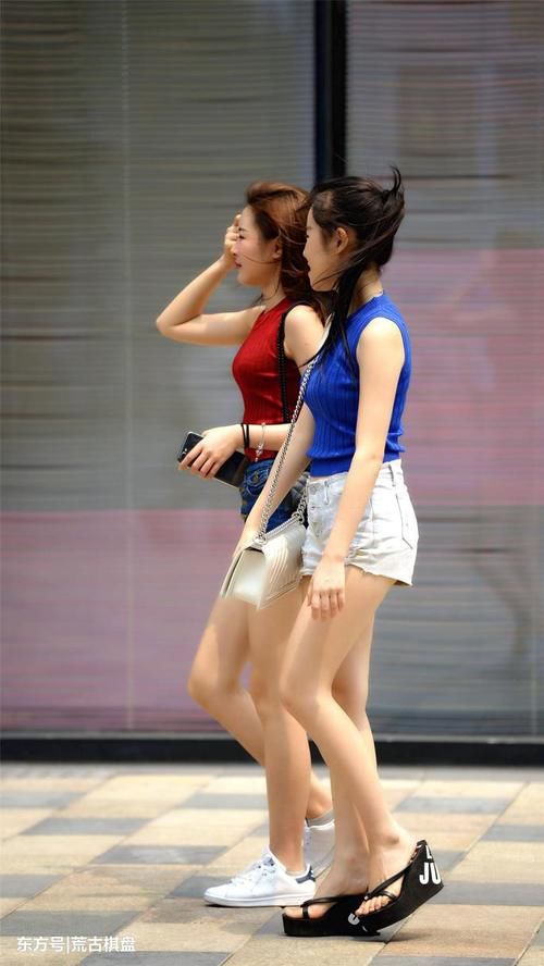 两位穿着热裤的姐姐虽然搭配色彩不同，但是更像是一对双胞胎姐妹