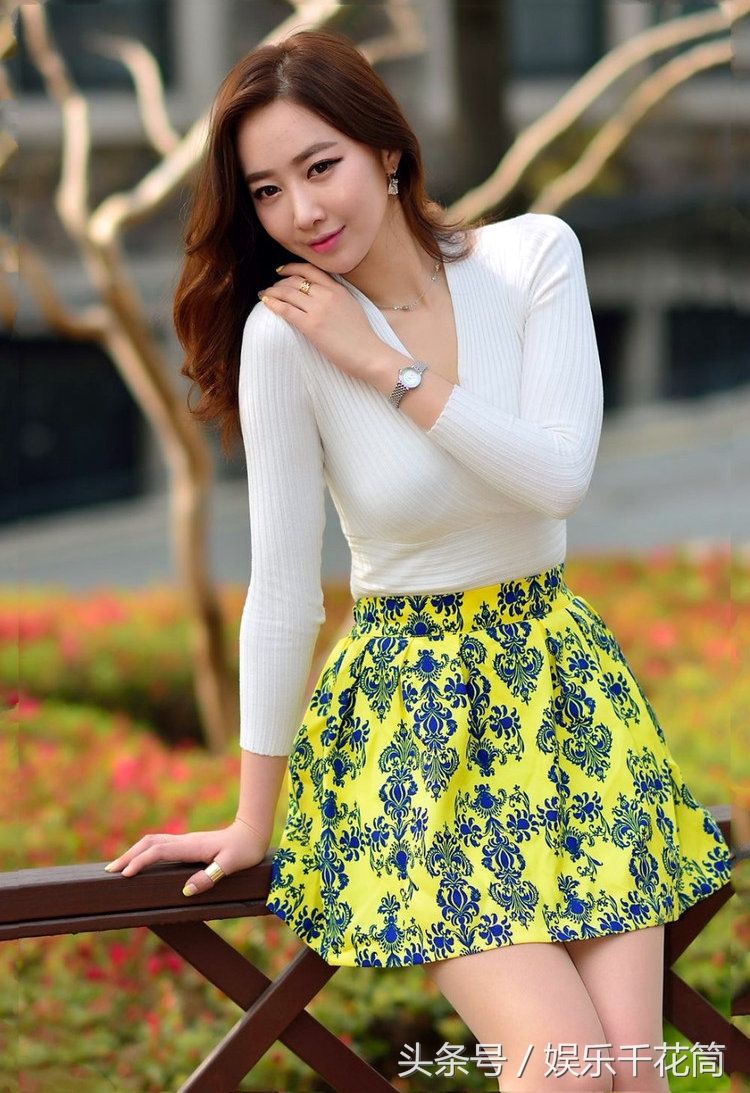 模特穿印花裙子少女感满满，坐路边栏杆心情很微妙