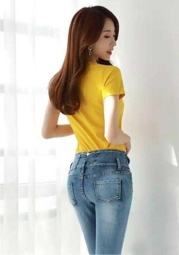 紧身牛仔裤线条简洁流畅，清爽美女气质优雅如一朵山茶花