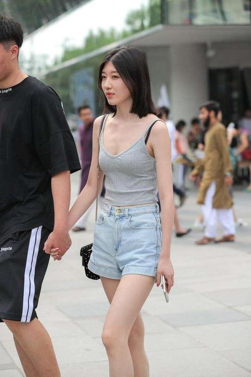 街拍：情侣牵手上街，女友吊带上衣性感十足，路人都忍不住多看！