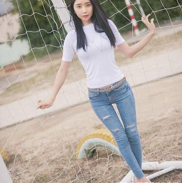 紧身牛仔裤线条简洁流畅，清爽美女气质优雅如一朵山茶花