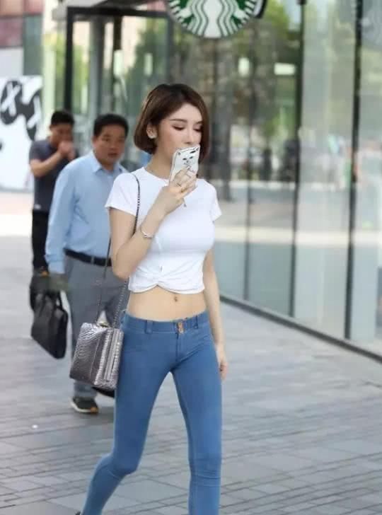街拍气质小姐姐紧身牛仔勾勒出厚实的臀部，身后的大叔看呆了