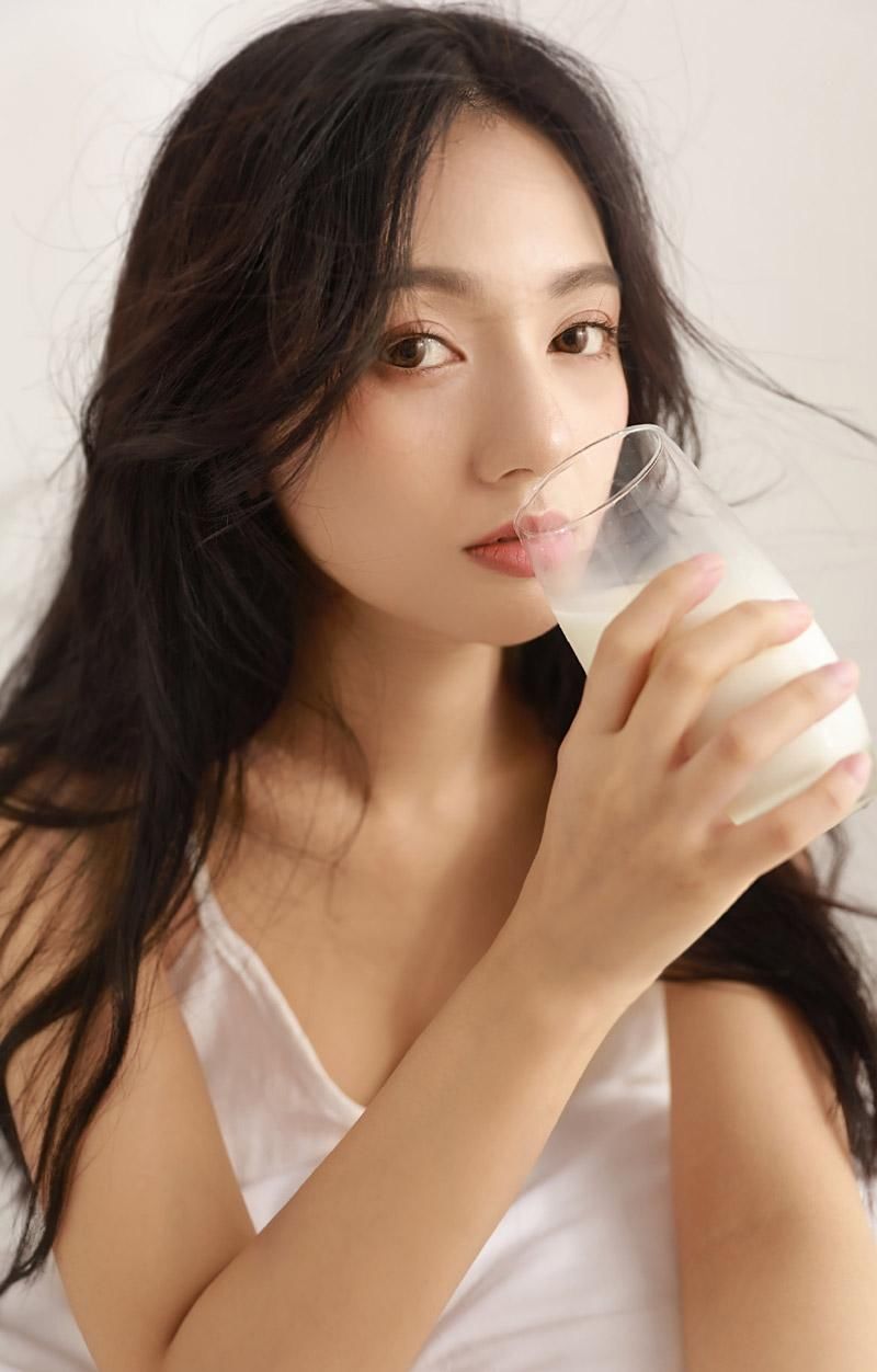 吊带裙美女性感慵懒床上写真图片