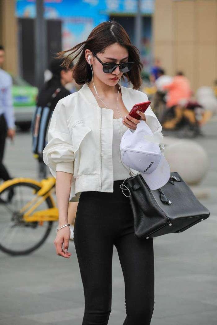 白上衣黑色紧身裤，既酷帅又不失女人味，这种感觉让人欲罢不能！