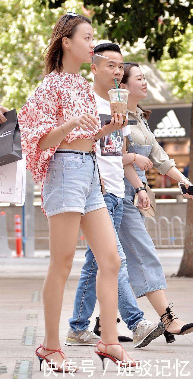 街拍：图五顽皮又可爱的小姐姐，露脐衫配短裤，青春靓丽又张扬