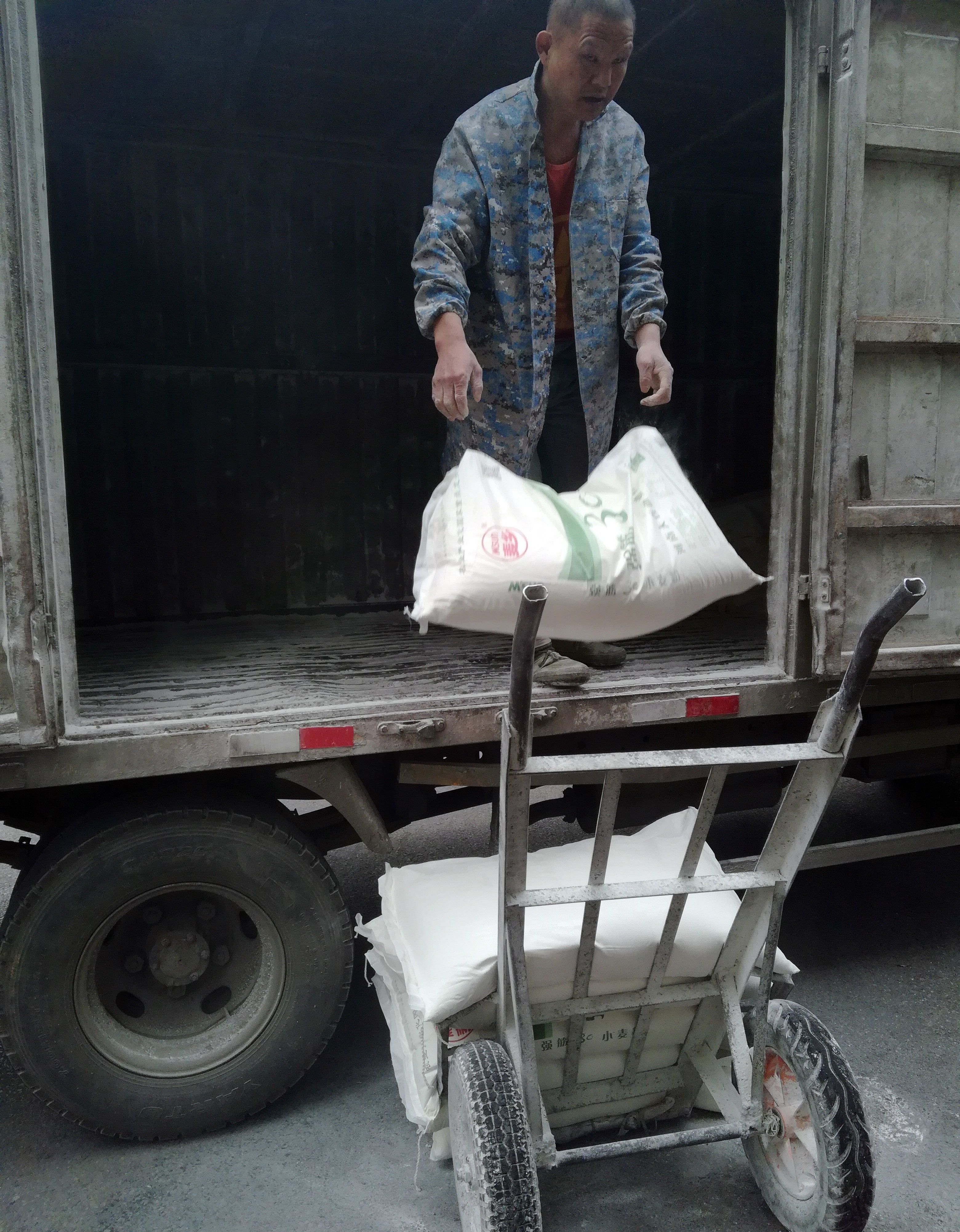 湖北宜昌:工人搬运面粉，白面腾飞;面粉来自河南