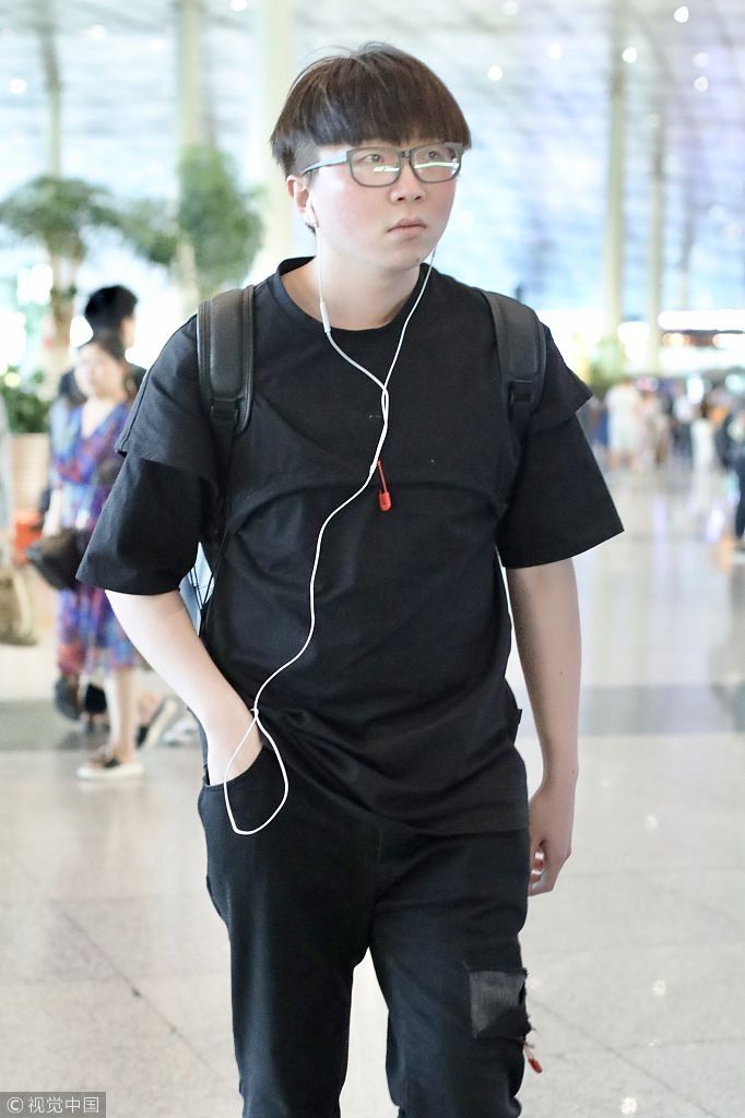 毛不易全黑look扮酷机场边走边听歌 “苹果脸”配“西瓜头”自带