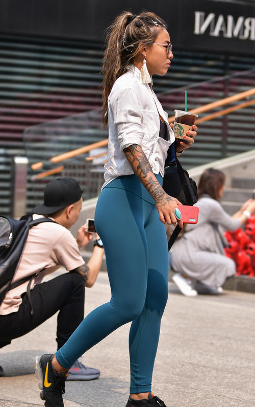 气质小姐姐紧身裤勾勒出丰腴臀线，亮银色的小眼镜跟肌肤呈现鲜明