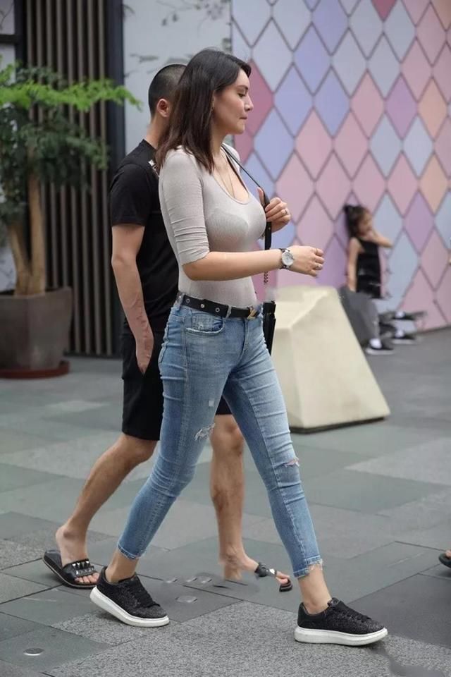 靓丽街拍:丰腴紧身牛仔裤辣妈，傲人身姿很惹眼，看着像混血美女!