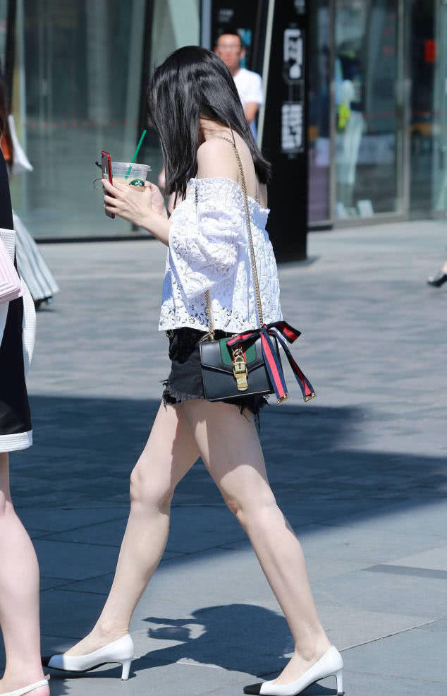 时尚姐妹花边喝奶茶边赶路，一个穿的像个围裙，一个镂空热裤大秀