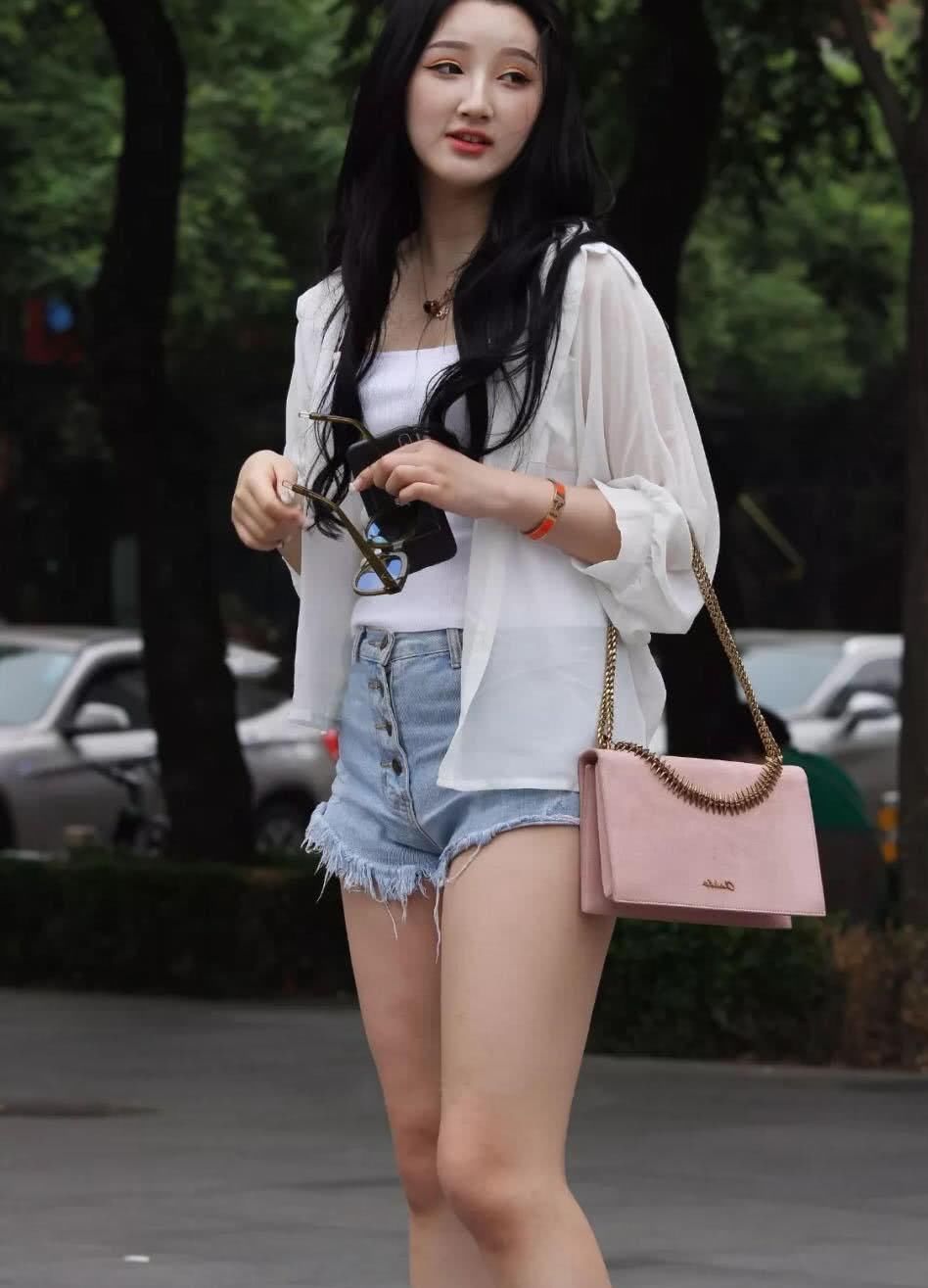 清新俏丽容颜的小美眉，吊带背心裹出傲人丰满上围