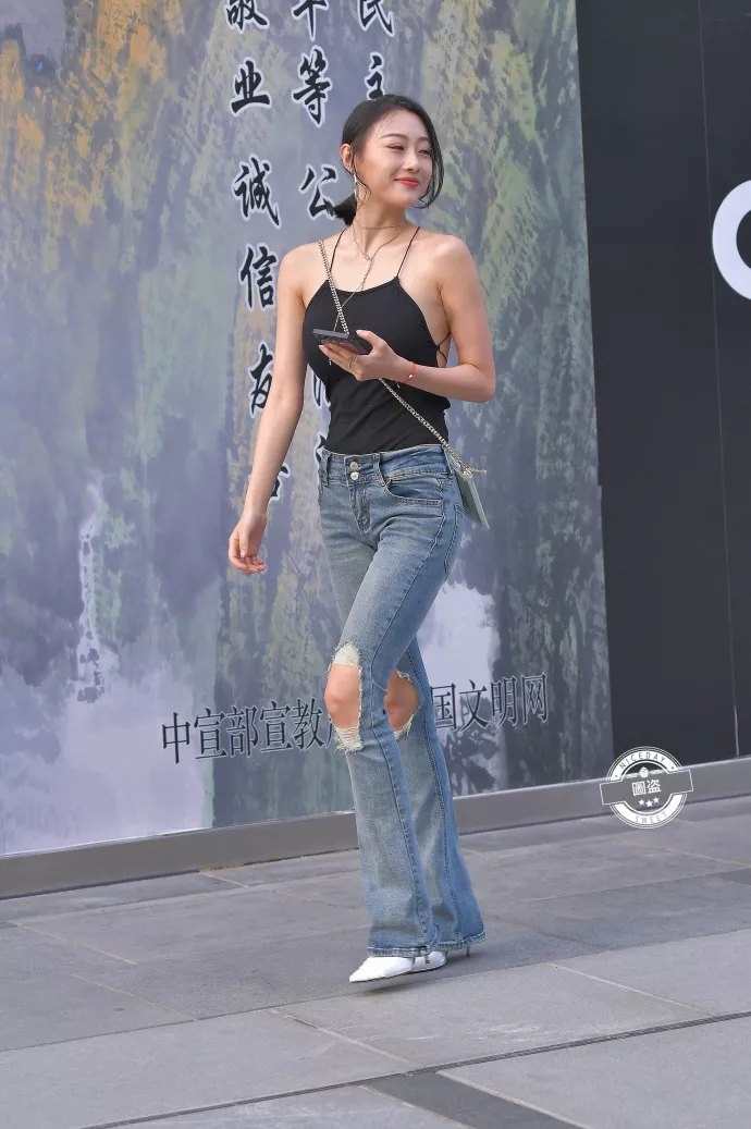 路人街拍,黑色上衣搭配牛仔裤,展示性感好身材,时尚潮流有魅力