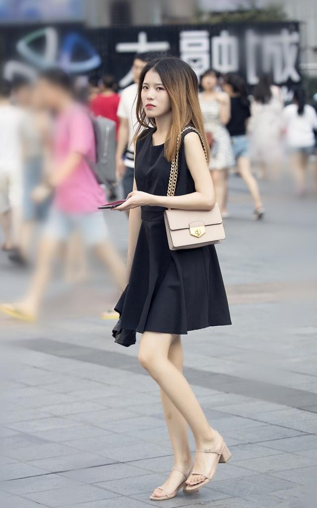 小姐姐身穿黑色吊带小短裙，很是性感