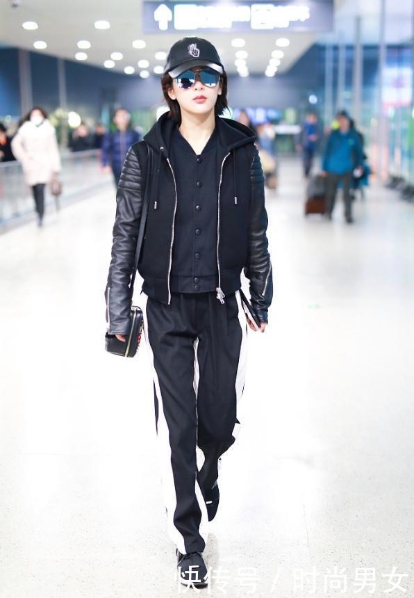 杨紫一身黑现机场，与身旁帅哥亲密耳语，网友：秦俊杰知道吗？