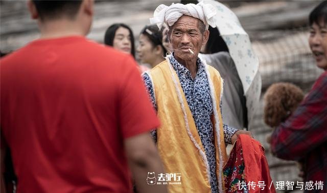 黄河瀑布边上的老汉牵毛驴给游客拍照，被拒绝也报以微笑