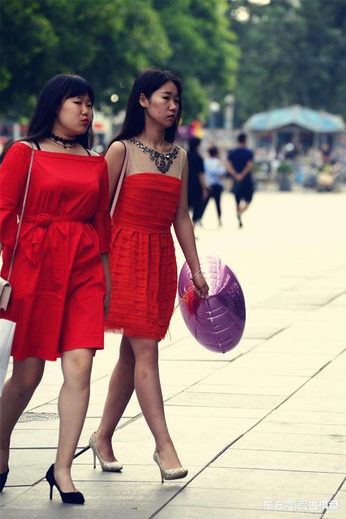 一对身材不同的闺蜜，她们穿着红裙，却搭配不一样的尖头细高跟鞋