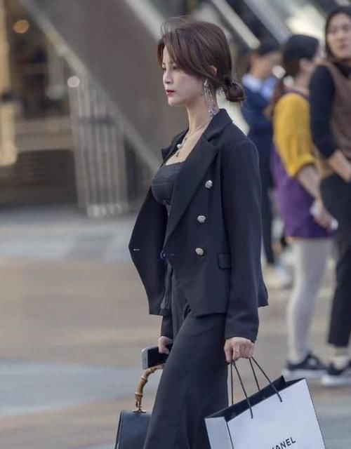  『羽绒服』街拍：一笑千金的美女，一件黑色长款羽绒服，时尚完美好身材