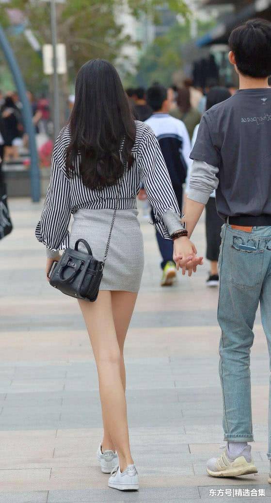 街拍：漂亮小姐姐穿包臀裙显出微胖身材，一双笔直的长腿很迷人