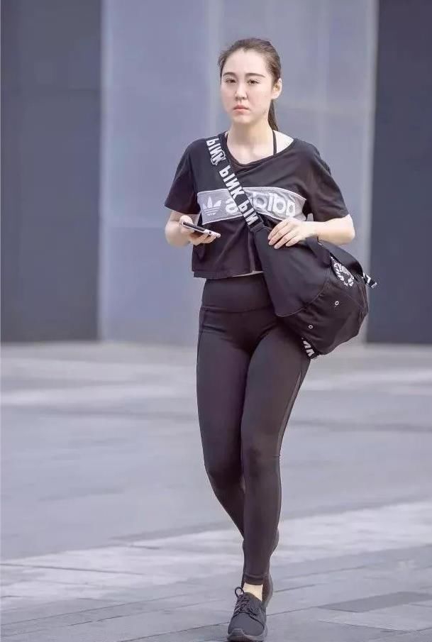 紧身裤小辣妹显凹凸线条，低头玩手机成了一道时尚风景线