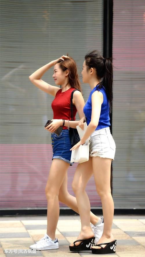 两位穿着热裤的姐姐虽然搭配色彩不同，但是更像是一对双胞胎姐妹