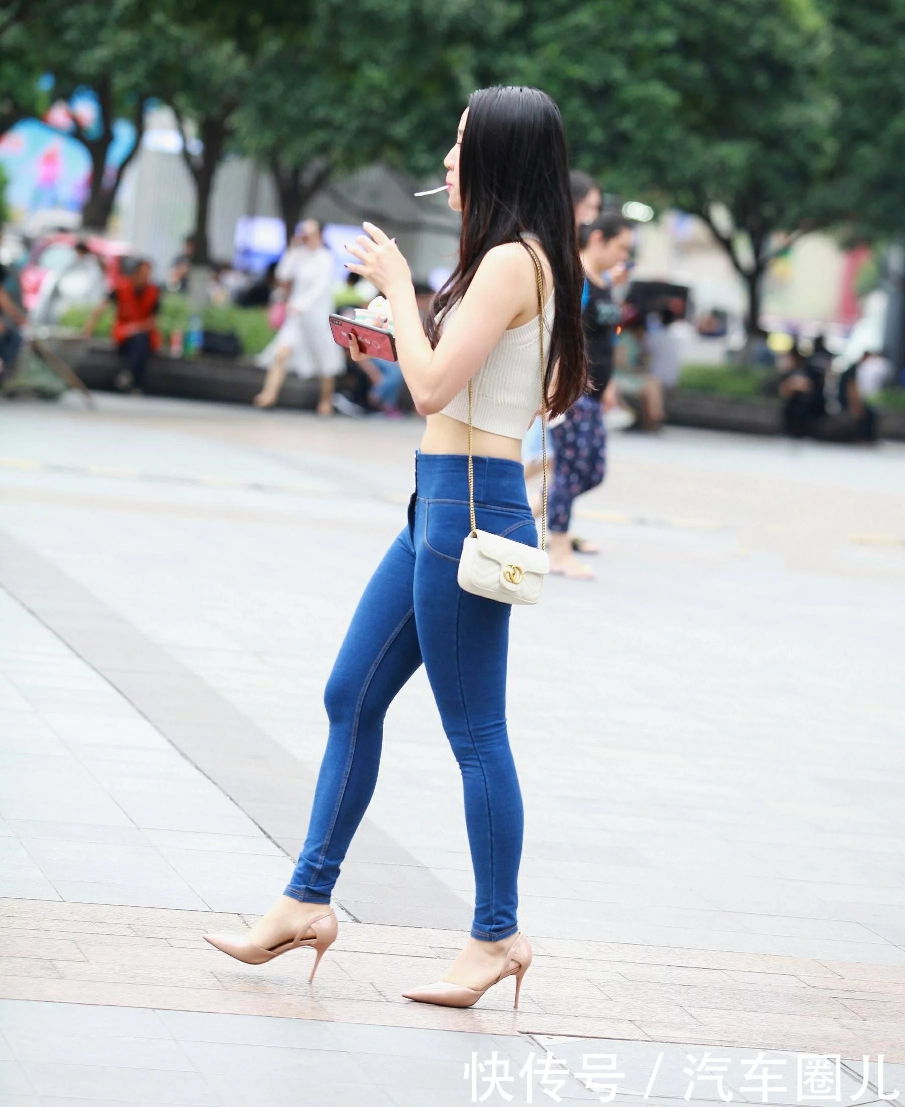 气质小姐姐紧身牛仔裤搭配大气十足，嘴里含着小勺子尽显可爱呆萌