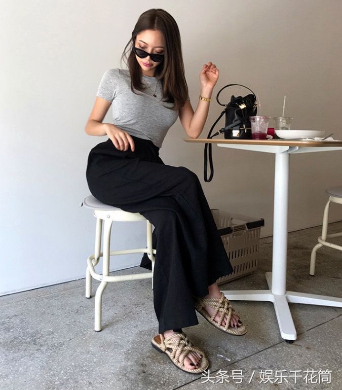模特一袭灰色T恤配黑色阔腿裤简约时尚，气质清冷不苟言笑