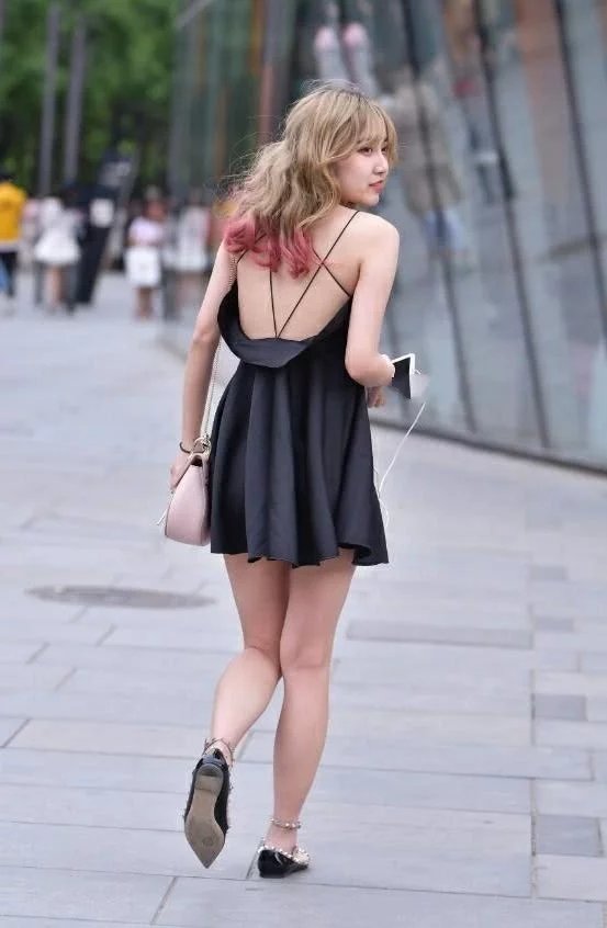 街拍：气质小姐姐吊带连衣裙大秀美背香肩，回眸一笑很俏皮