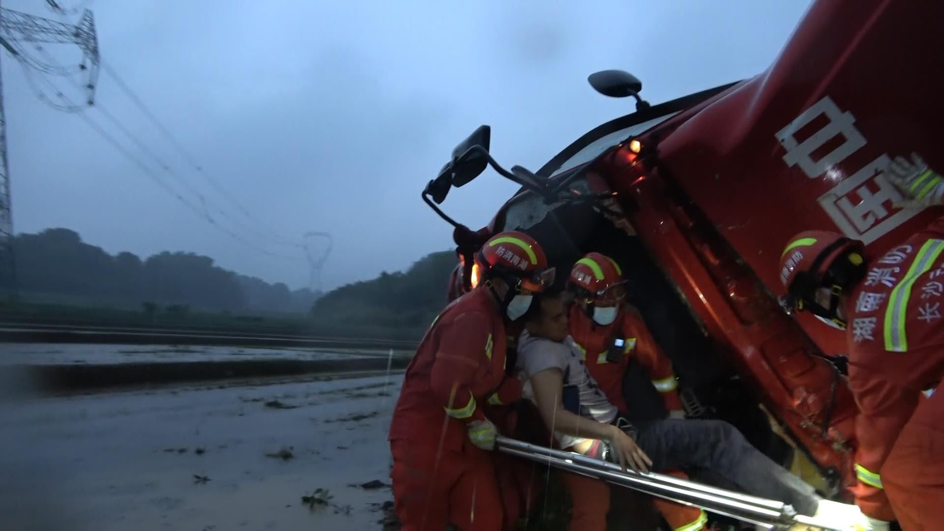 冲出：暴雨天路滑刹车失灵，货车冲出道路，驾驶员被牢牢卡在车里