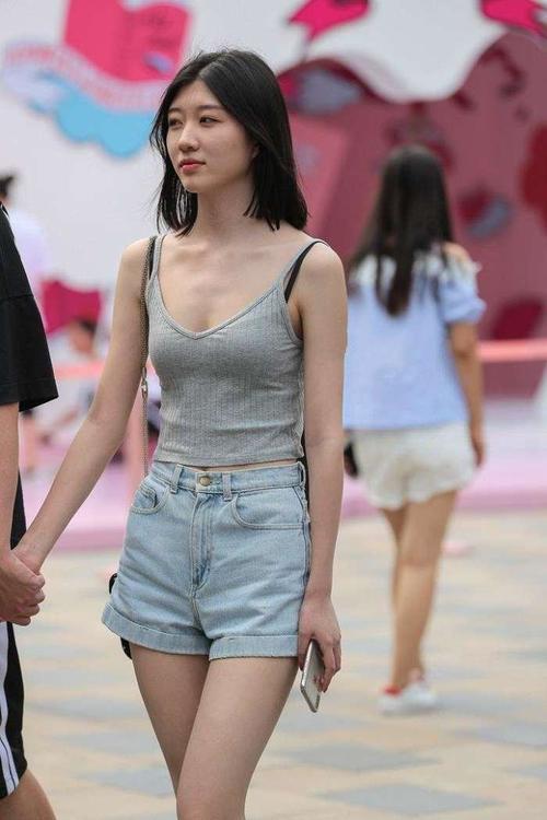 街拍:情侣牵手上街,女友吊带上衣性感十足,路人都忍不住多看!