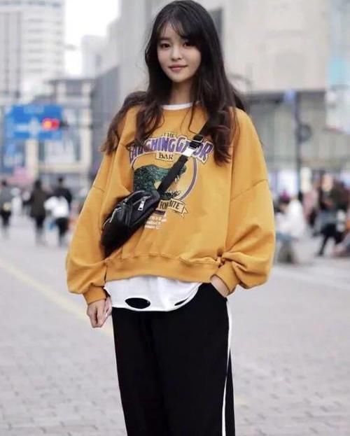  『风衣』养眼女神街拍：丹唇外朗的美女，一件黑色连衣裙外搭卡其色风衣，魅力十足