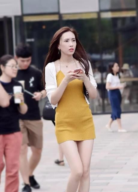 街拍:吊带小短裙,不仅秀肩还秀腿。委婉秀出女神气质!