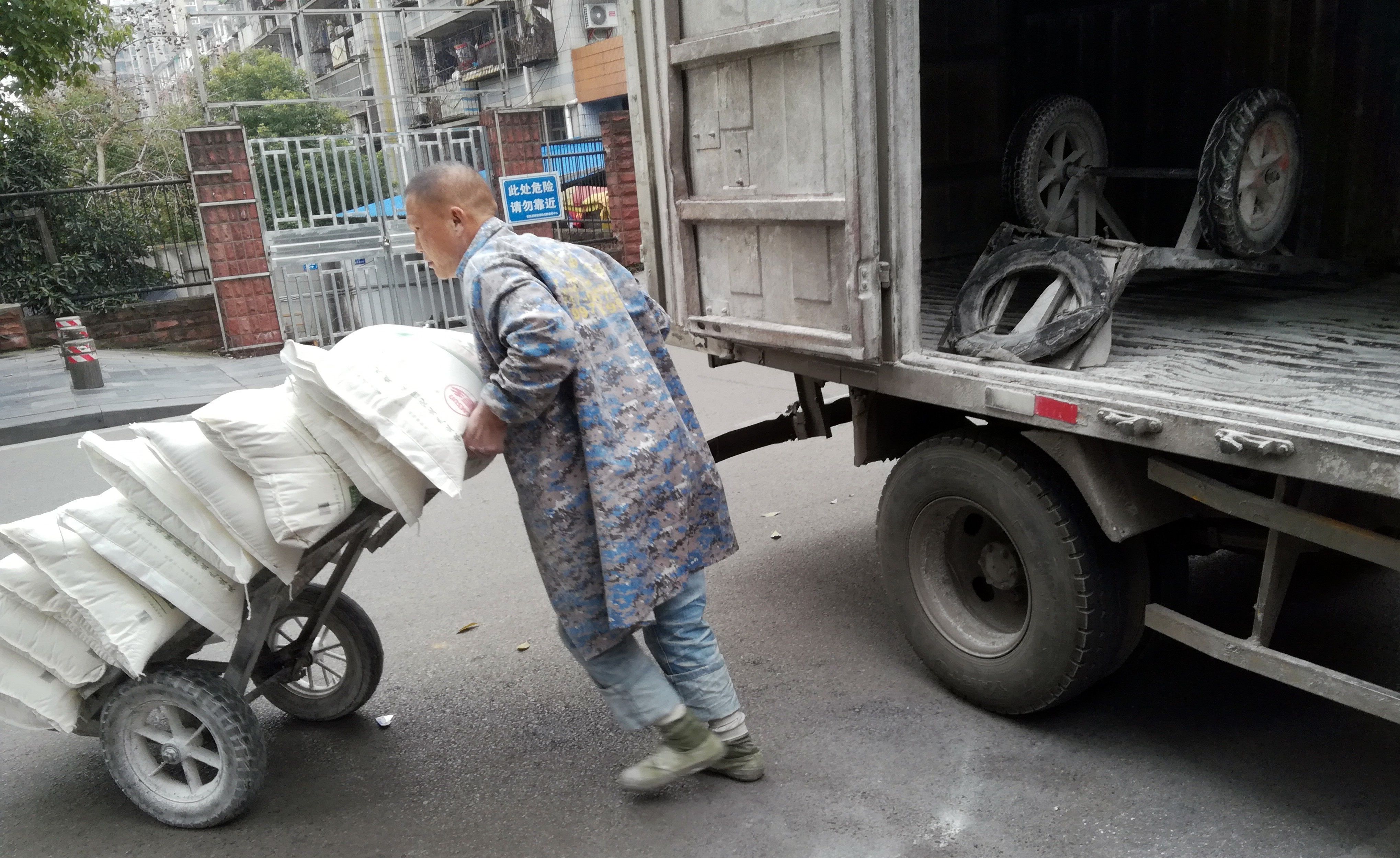 湖北宜昌:工人搬运面粉，白面腾飞;面粉来自河南
