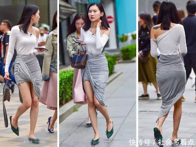 小姐姐太会穿，过膝的长裙将一边的裙角向上翻，是在故意秀美腿吗