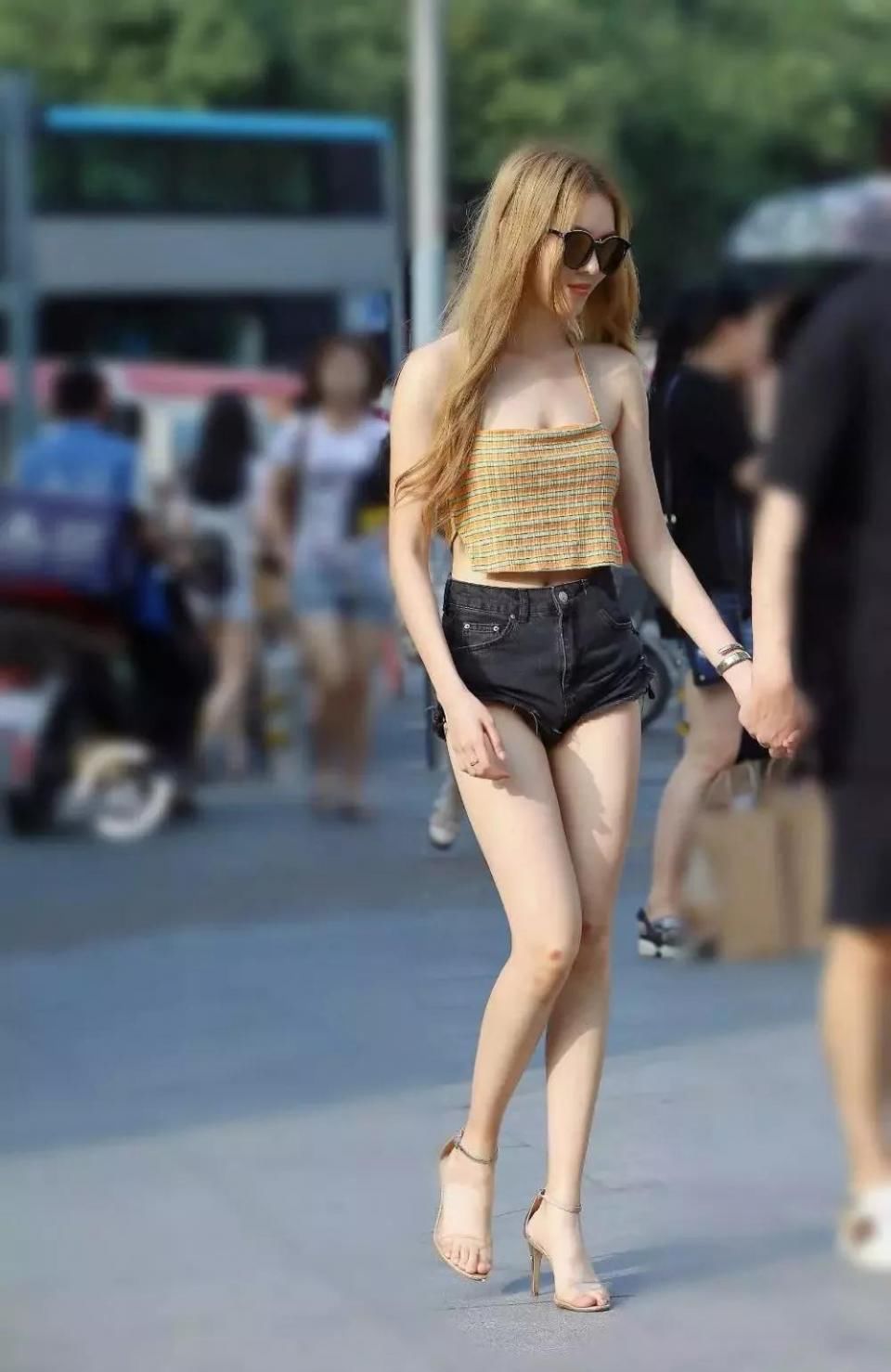 街拍美女:露背吊带美女尽显傲人身材 旁边的男友是不是太紧张了