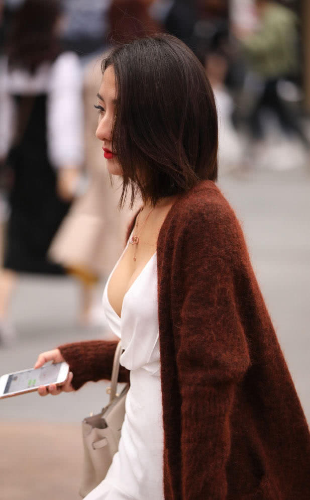 时尚小姐姐深V吊带连衣裙显出柔美曲线，轻抚着短发很迷人