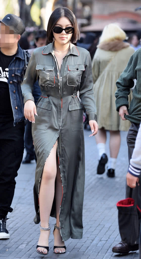 肉感小姐姐穿长款风衣裙秀出修长白皙的美腿，长相酷似千颂伊